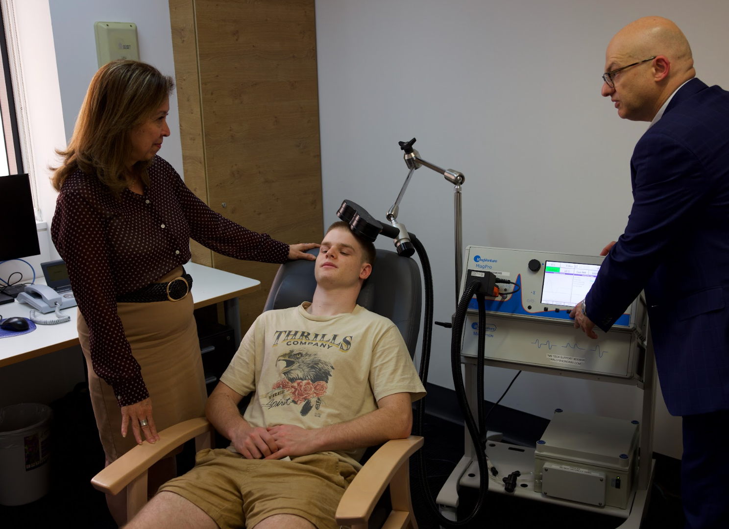 Dr Galambos treating a patient with transcranial magnetic stimulation (TMS).